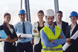 business people group on meeting and presentation in bright modern office with construction engineer architect and worker looking building model and blueprint plans